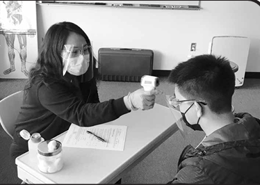 Student taking a temporal temperature